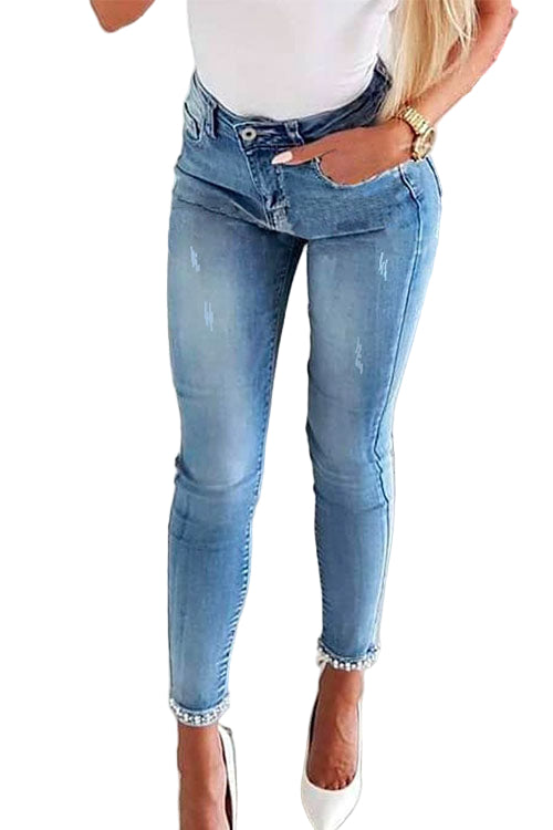 "Kvinnors denimbyxor med unik bågknut och pärldetaljer, formflatterande design, perfekt för alla tillfällen."