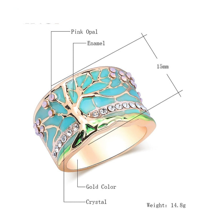 "Kvinnors elegant opalring med livets träd, i blått och grönt, symbol för styrka och stil, perfekt accessoar."