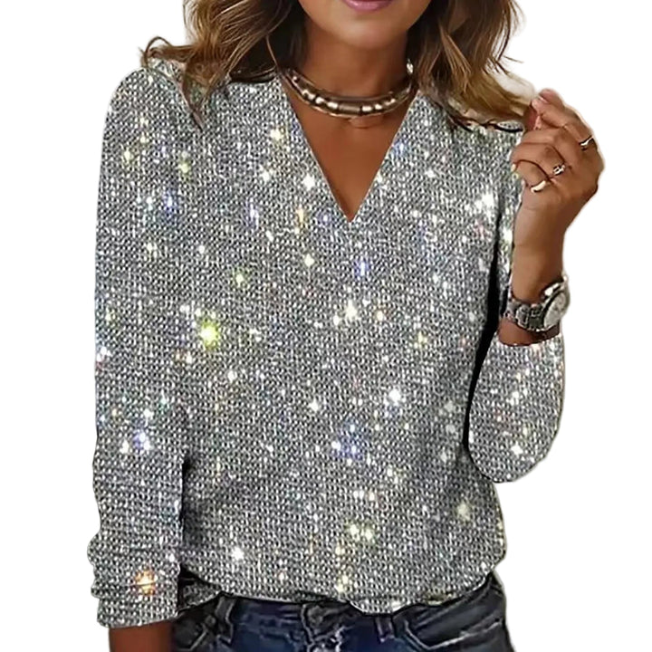 "Kvinnors glittrande festblus med paljetter, perfekt för kvällsevenemang och elegant styling, fångar uppmärksamheten."