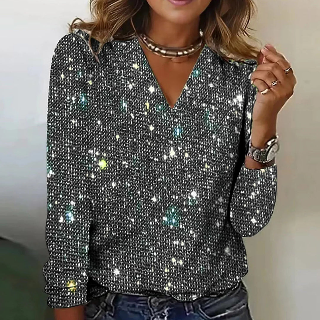 "Kvinnors glittrande festblus med paljetter, perfekt för kvällsevenemang och elegant styling, fångar uppmärksamheten."