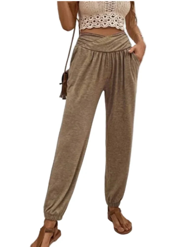 "Kvinnors högmidjade byxor i elastiskt material, enfärgad design med fickor, elegant och smickrande stil."