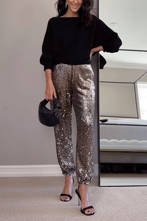 Kvinnors högmidjade glittrande joggers med skimrande paljetter, perfekt för både vardag och fest. Eleganta och bekväma.