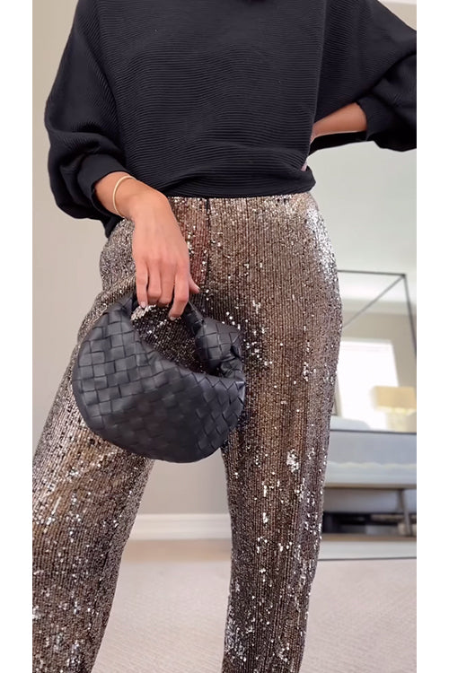 Kvinnors högmidjade glittrande joggers med skimrande paljetter, perfekt för både vardag och fest. Eleganta och bekväma.