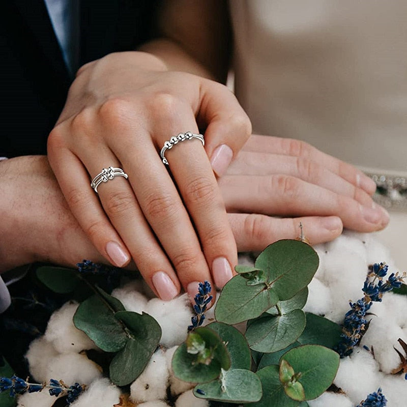 "Kvinnors justerbara fidget ring med pärlor, guld och silver, geometrisk design, lugnande accessoar mot stress."