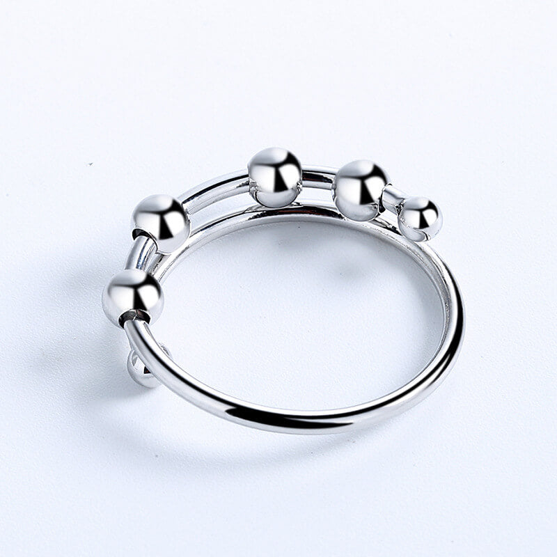 "Kvinnors justerbara fidget ring med pärlor, guld och silver, geometrisk design, lugnande accessoar mot stress."