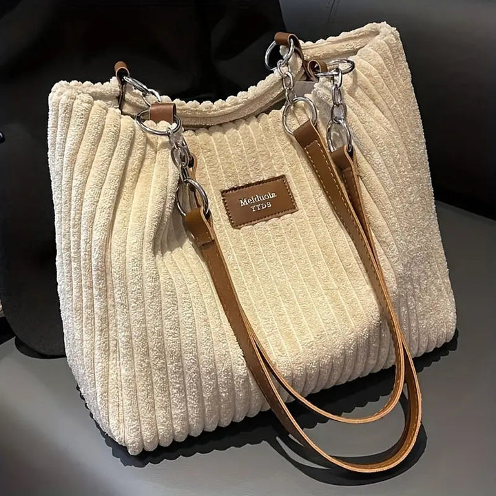 "Kvinnors rymlig corduroy handväska i mjuk beige med minimalistisk design och justerbar rem."
