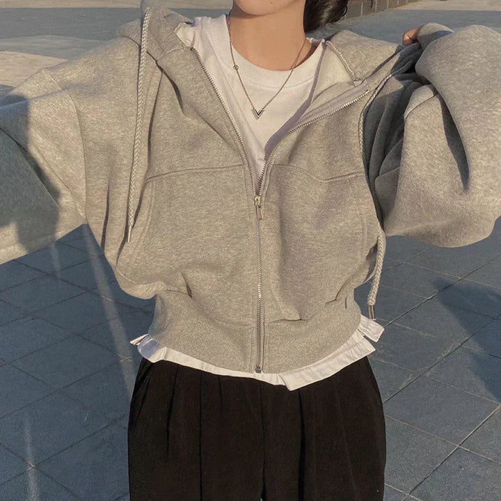 "Kvinnors trendig hoodie med dragkedja och sluttande axlar i modern passform, mångsidig design i olika färger."