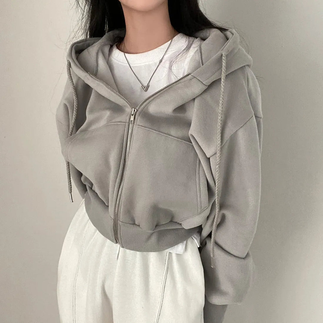 "Kvinnors trendig hoodie med dragkedja och sluttande axlar i modern passform, mångsidig design i olika färger."
