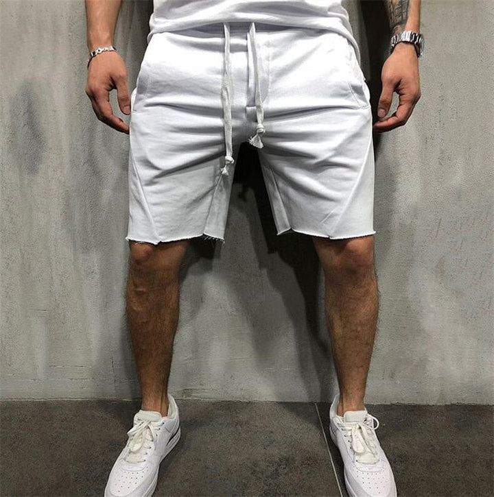 Lösa herrshorts i andningsbart tyg med dragsko och elastiskt midjeband, perfekt för sommar och fritidsaktiviteter.