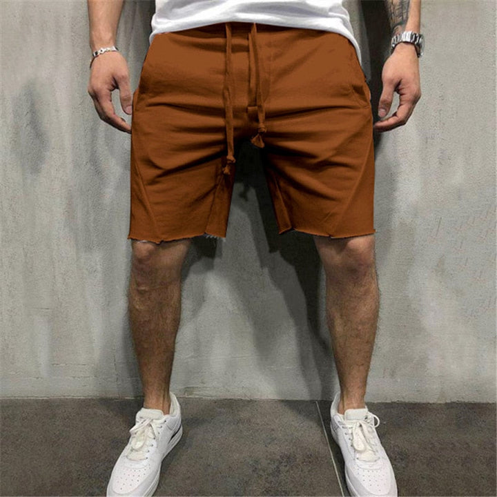 Lösa herrshorts i andningsbart tyg med dragsko och elastiskt midjeband, perfekt för sommar och fritidsaktiviteter.