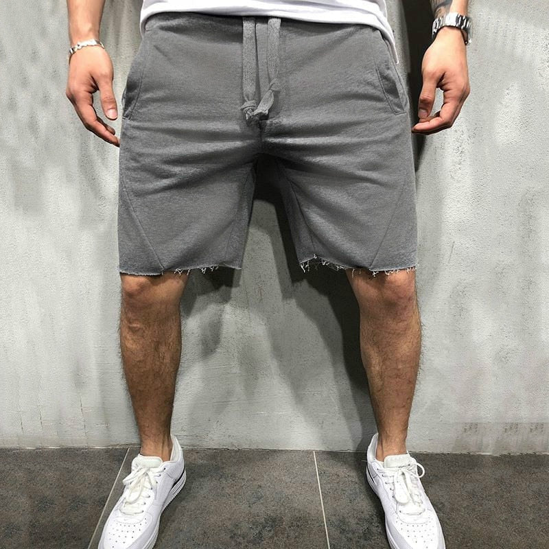 Lösa herrshorts i andningsbart tyg med dragsko och elastiskt midjeband, perfekt för sommar och fritidsaktiviteter.