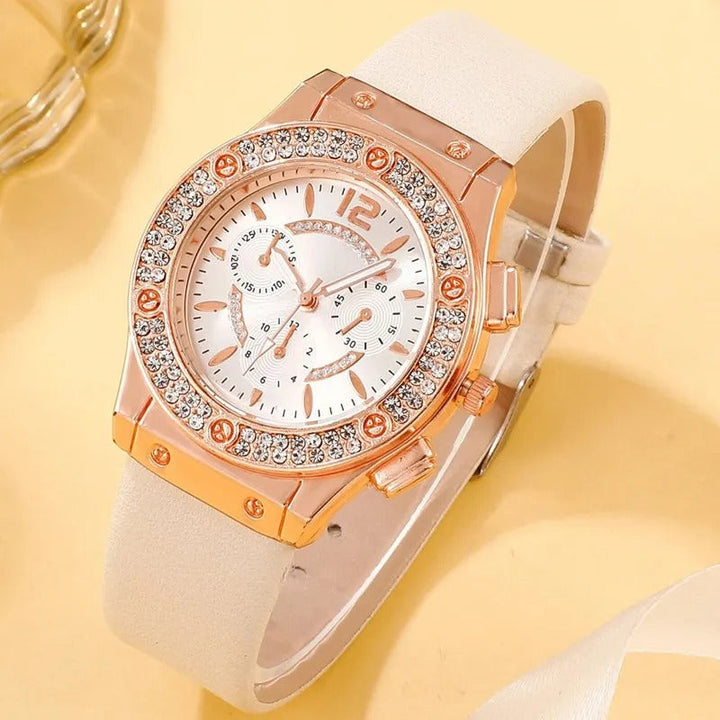 "Lyxig damklocka med strass, rosa band och kvartsurverk. Elegant och gnistrande design för en sofistikerad look."