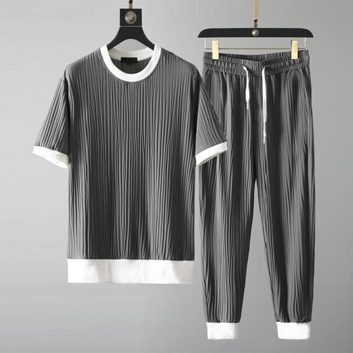 Mäns casual set för höst med O-hals tröja och avslappnade byxor i blå, svart, grå och vit för stil och komfort.