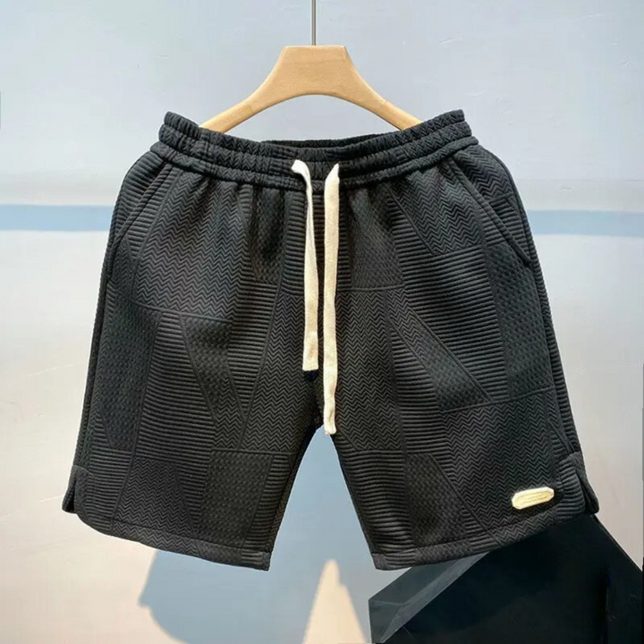 "Mäns sportshorts med vågmönster, justerbar midja och bekväm passform, perfekt för träning och fritid."