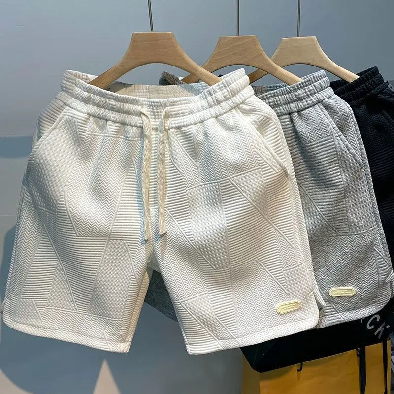 "Mäns sportshorts med vågmönster, justerbar midja och bekväm passform, perfekt för träning och fritid."