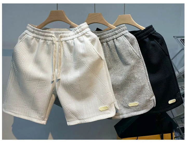 "Mäns sportshorts med vågmönster, justerbar midja och bekväm passform, perfekt för träning och fritid."