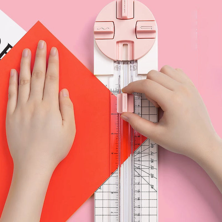 "Multifunktionell 4-i-1 pappersskärare i rosa och blå plast, perfekt för hantverk som scrapbooking med precisionsskärning."