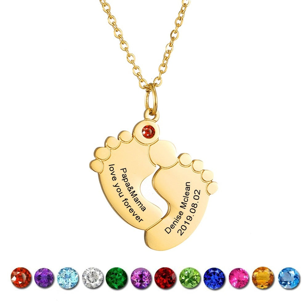 "Personligt halsband i guld med babyfötter och graverade namn, perfekt för mödrar, moderna och elegant design."