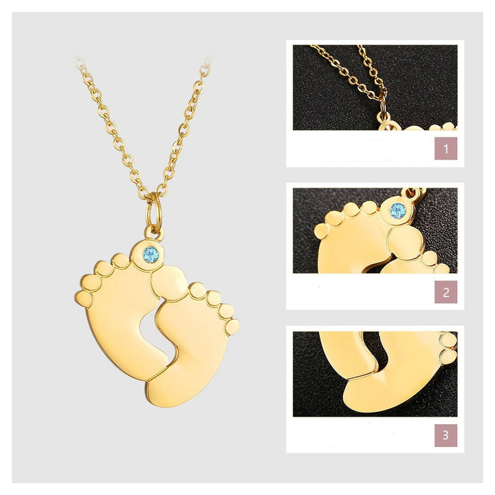 "Personligt halsband i guld med babyfötter och graverade namn, perfekt för mödrar, moderna och elegant design."