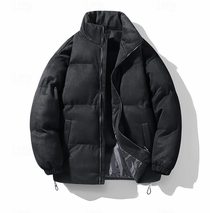"Quiltad herr vinterjacka i modern stil, elegant design, svart färg, värmande och bekväm för kalla dagar, lätt att styla."
