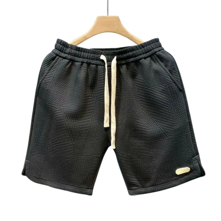 "Stilrena herrshorts med iögonfallande vågmönster och justerbar dragsko för optimal komfort och flexibilitet."