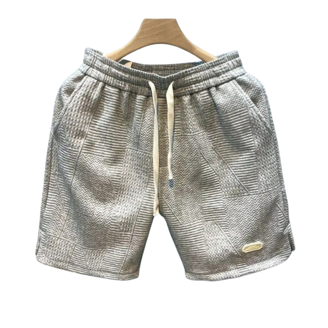 "Stilrena herrshorts med iögonfallande vågmönster och justerbar dragsko för optimal komfort och flexibilitet."