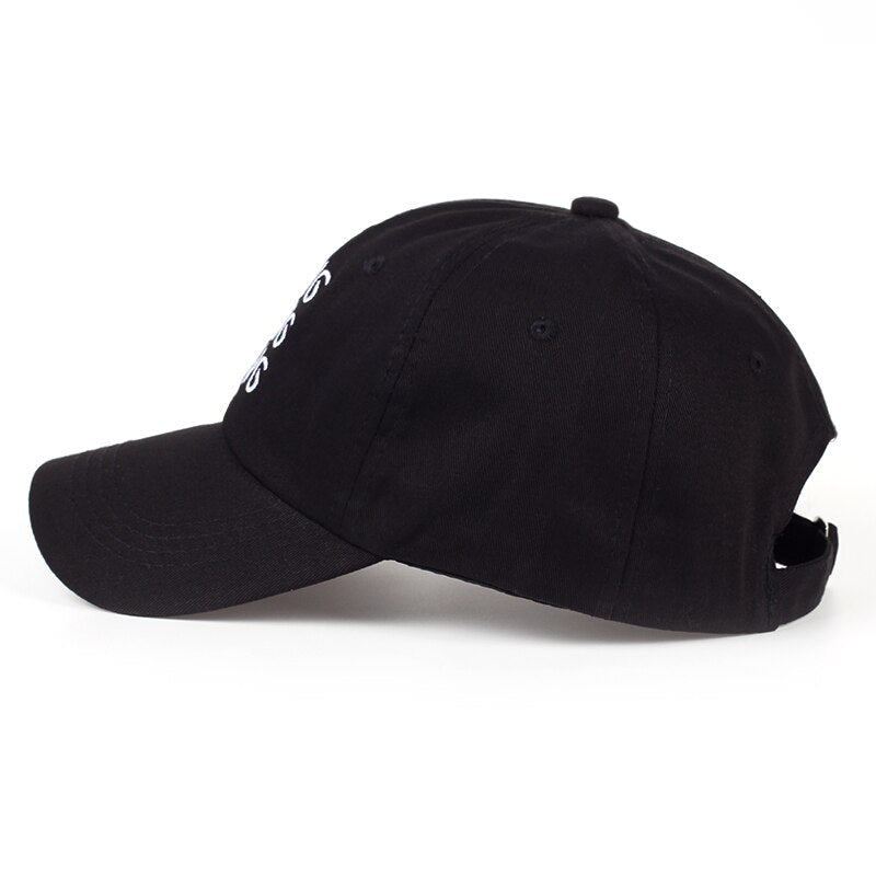 "Svart unisex baseballkeps med justerbar rem, böjd visir och broderade bokstäver. Accessoar för stil och komfort."