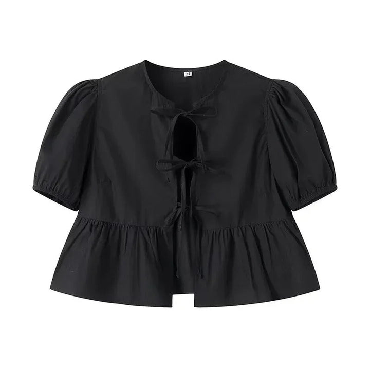 "Svartvit ruffle crop top med framtid rosett, puffärmar och elegant design, perfekt för kvinnor som älskar stilrena toppar."