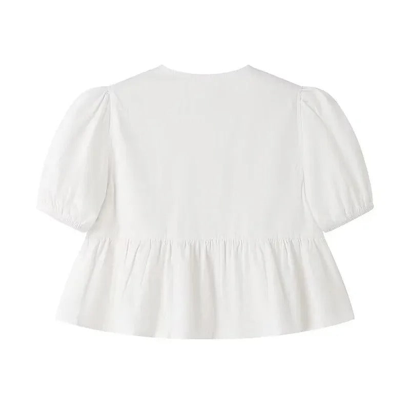"Svartvit ruffle crop top med framtid rosett, puffärmar och elegant design, perfekt för kvinnor som älskar stilrena toppar."