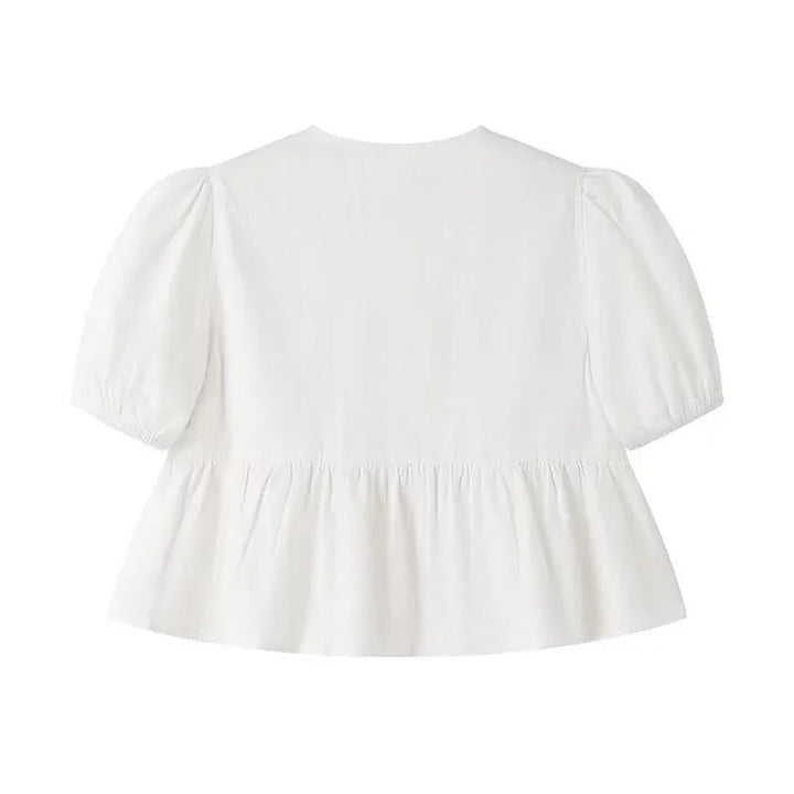 "Svartvit ruffle crop top med framtid rosett, puffärmar och elegant design, perfekt för kvinnor som älskar stilrena toppar."