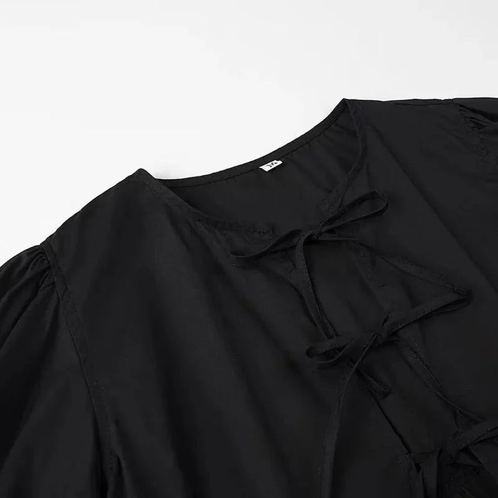 "Svartvit ruffle crop top med framtid rosett, puffärmar och elegant design, perfekt för kvinnor som älskar stilrena toppar."