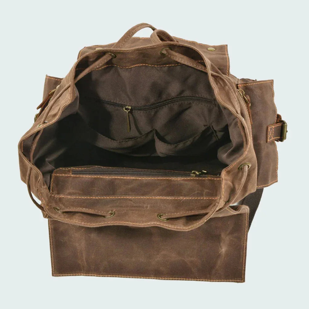 "Unisex ryggsäck i vintage stil, dragskostängning, vaxad canvas, brunt läder, ergonomiska axelband, stor förvaring."