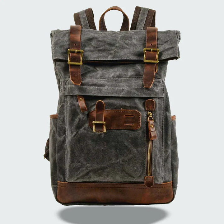 "Unisex vikbar vintage ryggsäck i vaxad canvas, stilren och funktionell, med vadderade axelremmar och flera fickor."