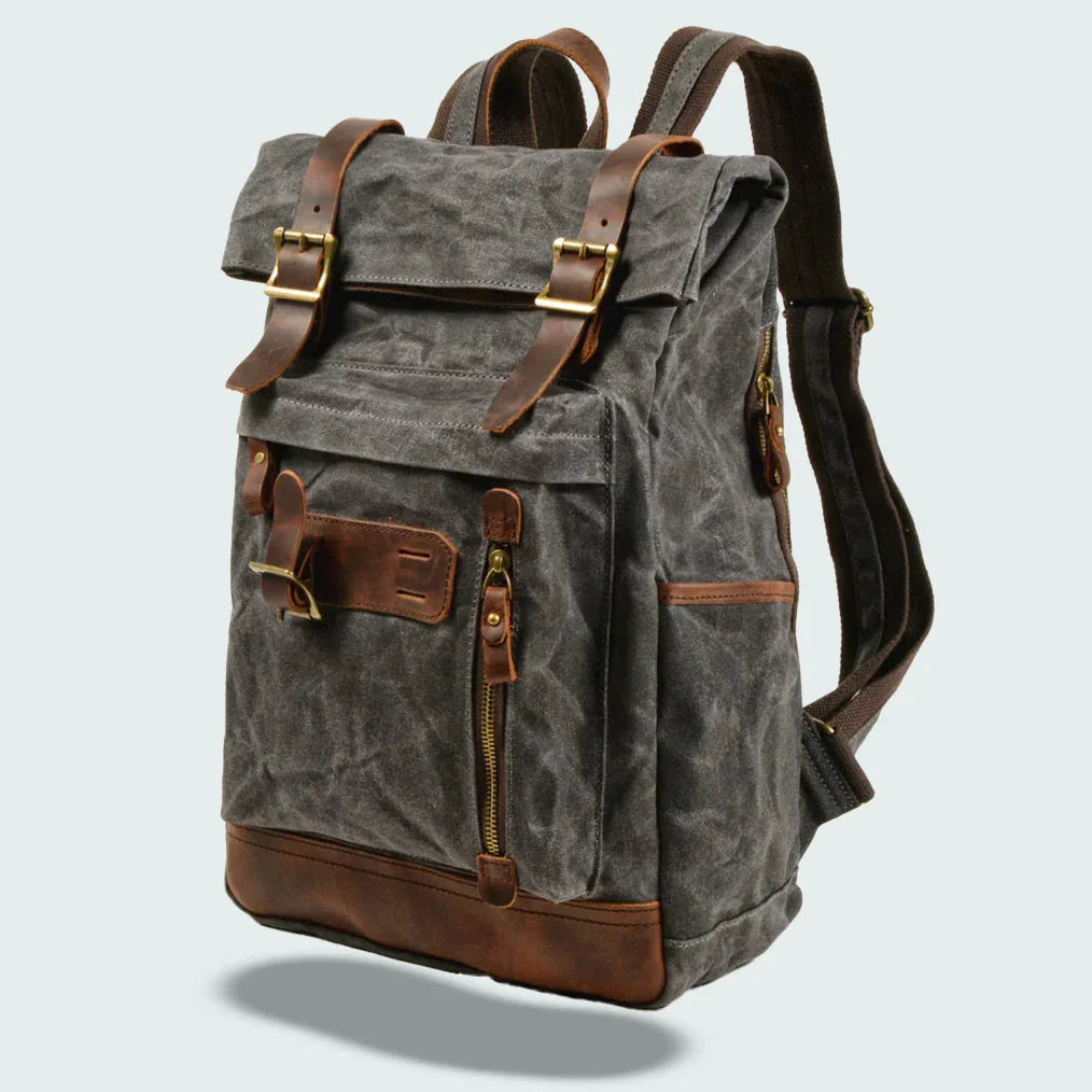 "Unisex vikbar vintage ryggsäck i vaxad canvas, stilren och funktionell, med vadderade axelremmar och flera fickor."