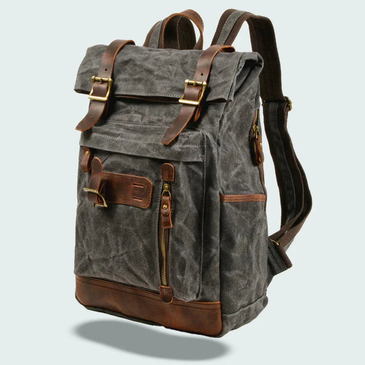 "Unisex vikbar vintage ryggsäck i vaxad canvas, stilren och funktionell, med vadderade axelremmar och flera fickor."