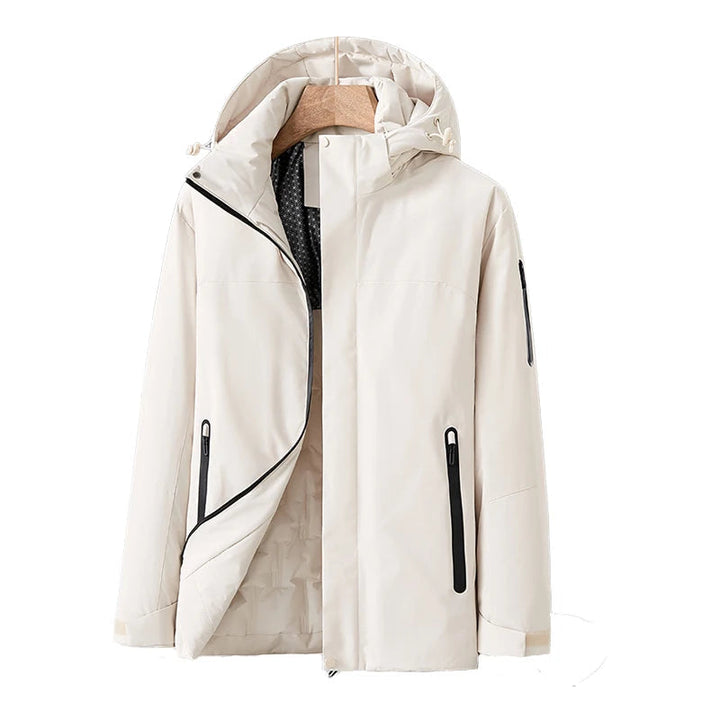 Vattentät damjacka i blå kvilt med avtagbar hätta, fickor, modern stil, perfekt för vinter och dåligt väder.