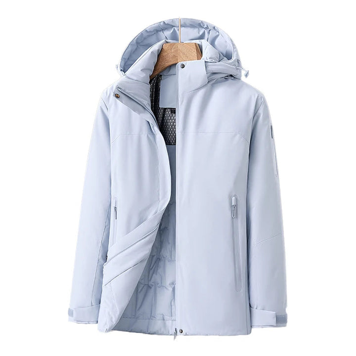 Vattentät damjacka i blå kvilt med avtagbar hätta, fickor, modern stil, perfekt för vinter och dåligt väder.
