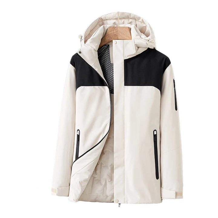 Vattentät damjacka i blå kvilt med avtagbar hätta, fickor, modern stil, perfekt för vinter och dåligt väder.