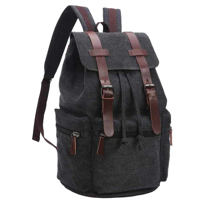 "Vintage herrryggsäck i slitstark canvas med läderdetaljer, lock och fickor, perfekt för vardag och äventyr."