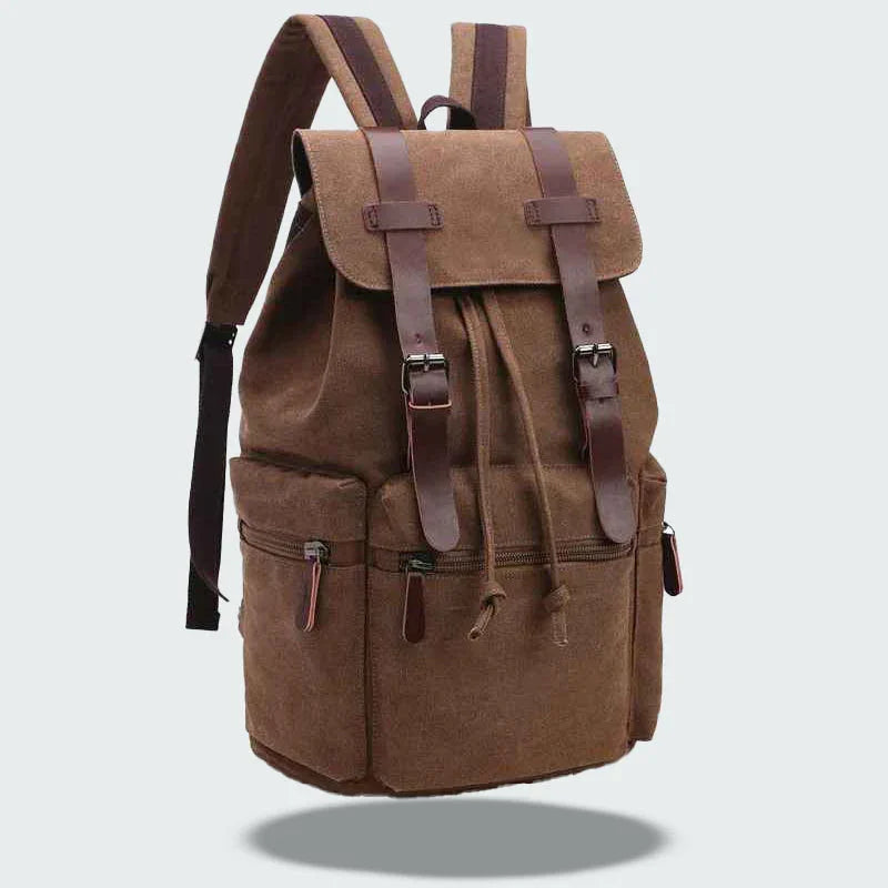 "Vintage herrryggsäck i slitstark canvas med läderdetaljer, lock och fickor, perfekt för vardag och äventyr."