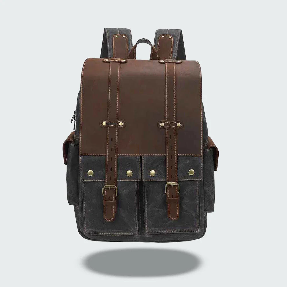 "Vintage kameraryggsäck i vaxad bomull och läder, herrmodell. Stilren design med bruna läderdetaljer och klassisk look."