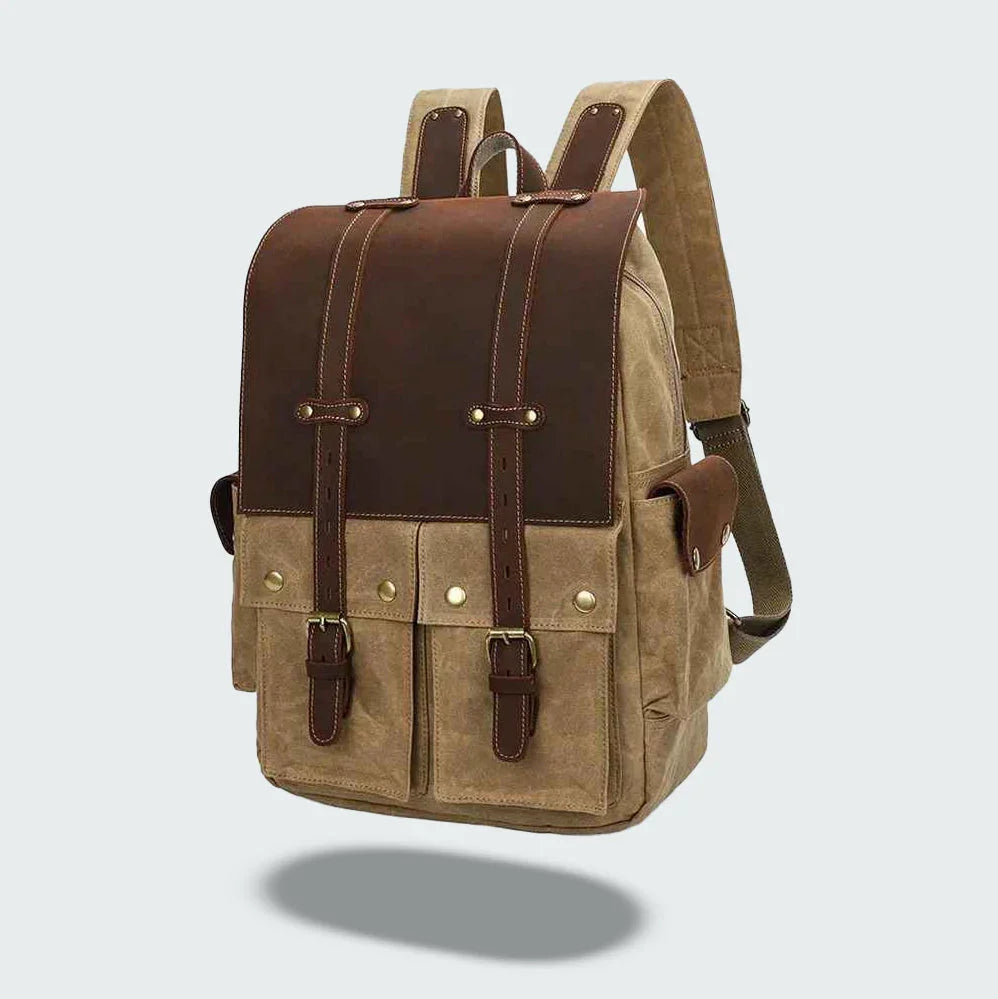 "Vintage kameraryggsäck i vaxad bomull och läder, herrmodell. Stilren design med bruna läderdetaljer och klassisk look."