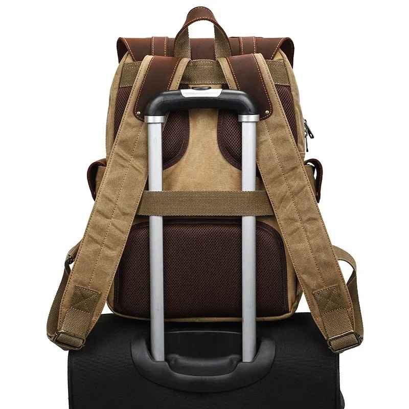 "Vintage kameraryggsäck i vaxad bomull och läder, herrmodell. Stilren design med bruna läderdetaljer och klassisk look."