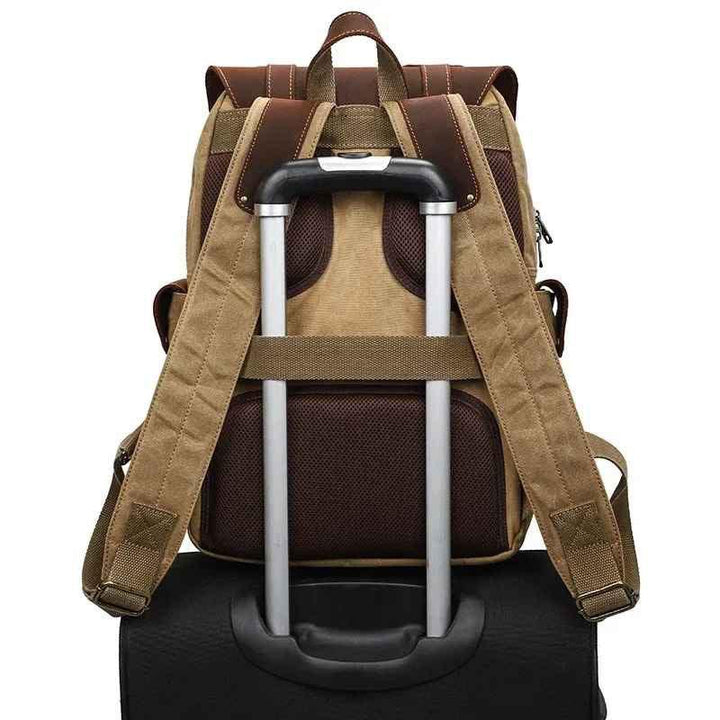 "Vintage kameraryggsäck i vaxad bomull och läder, herrmodell. Stilren design med bruna läderdetaljer och klassisk look."