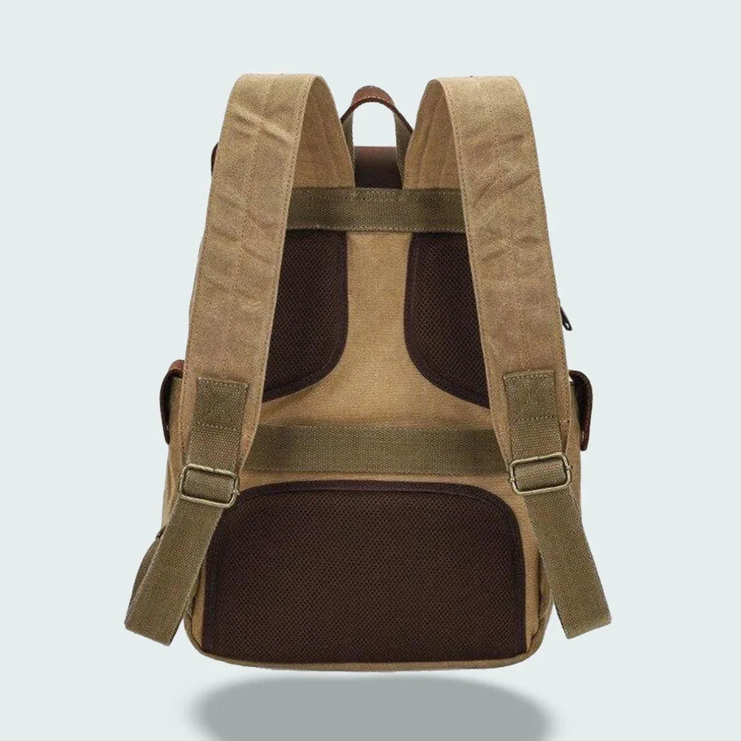 "Vintage kameraryggsäck i vaxad bomull och läder, herrmodell. Stilren design med bruna läderdetaljer och klassisk look."