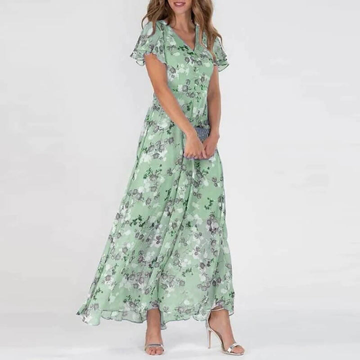 Lång sommarklänning med blommigt mönster och smickrande passform