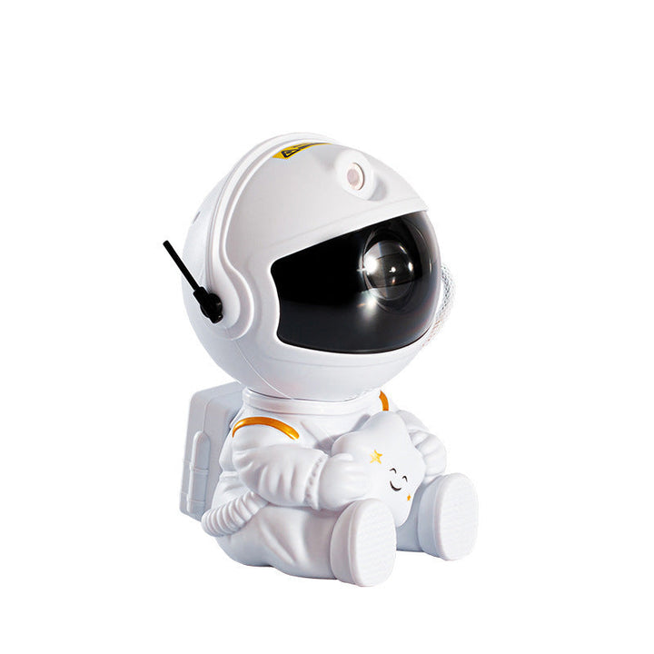 "Astronautprojektorlampa med stjärnhimmel, vit astronautfigur, projicerar 360° ljus och stjärnor i ett rum."