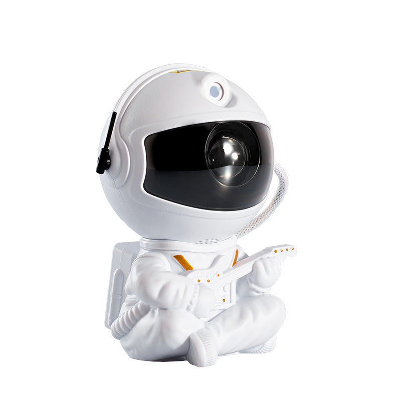 "Astronautprojektorlampa med stjärnhimmel, vit astronautfigur, projicerar 360° ljus och stjärnor i ett rum."