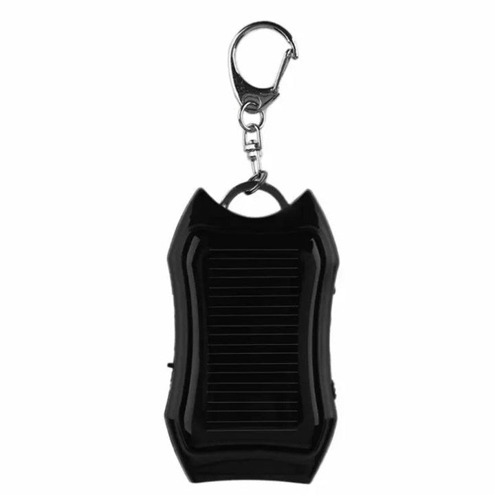 Bärbar mini powerbank på nyckelring, svart och vit, kompakt design, perfekt för resor och enkel att bära med sig.