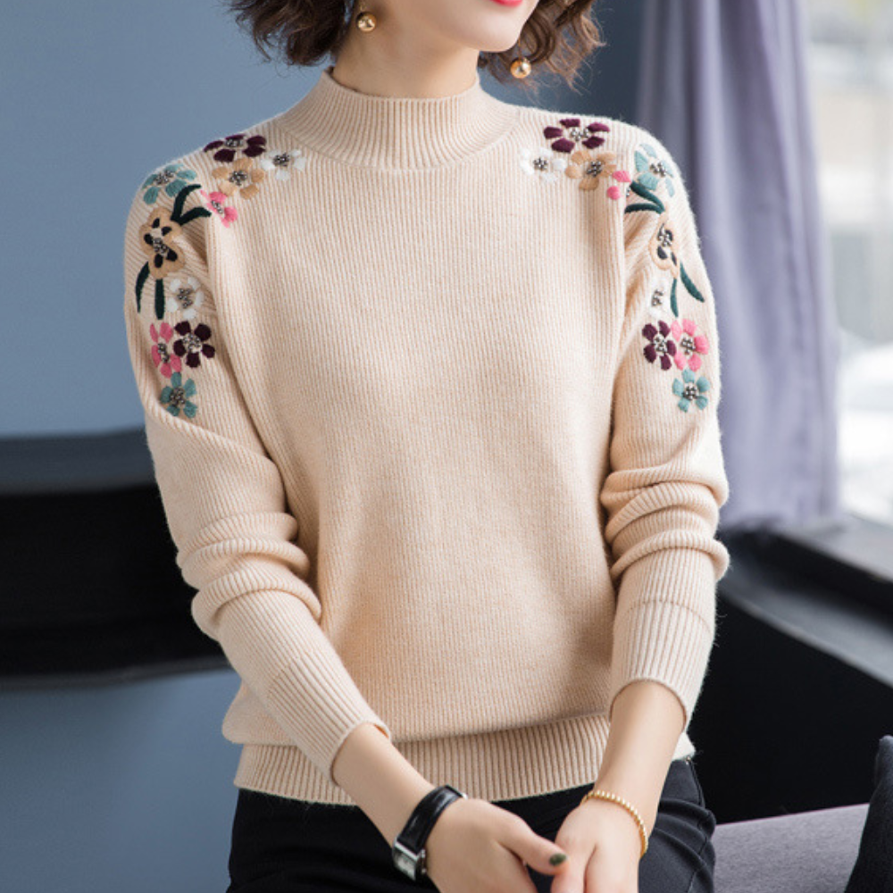 Höstig damtröja med vackert blommönster. Långärmad pullover i stickat material för kvinnors vintermode.